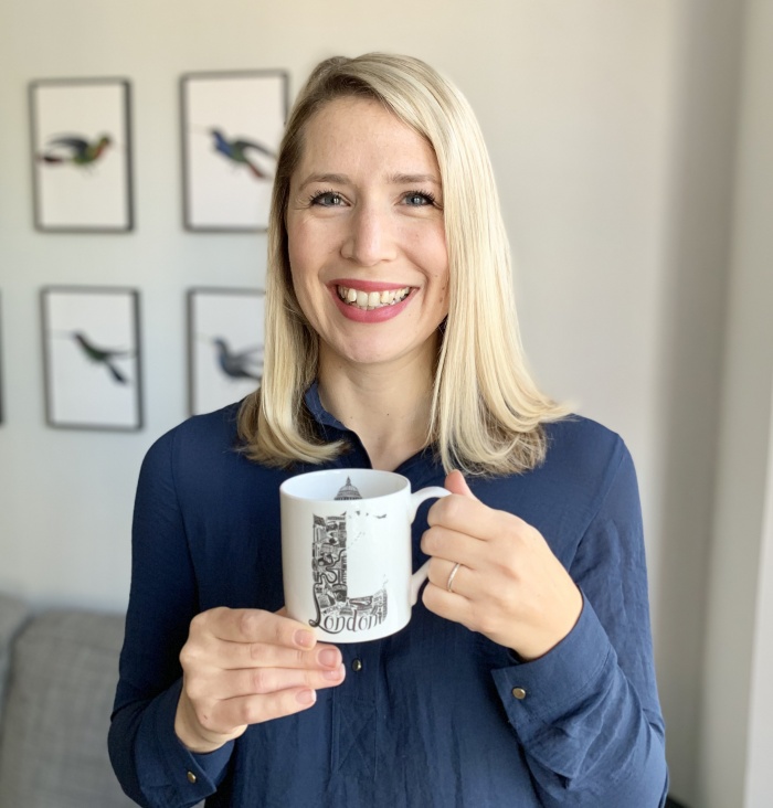 The artist Lucy Loves this holding the mug she designed 